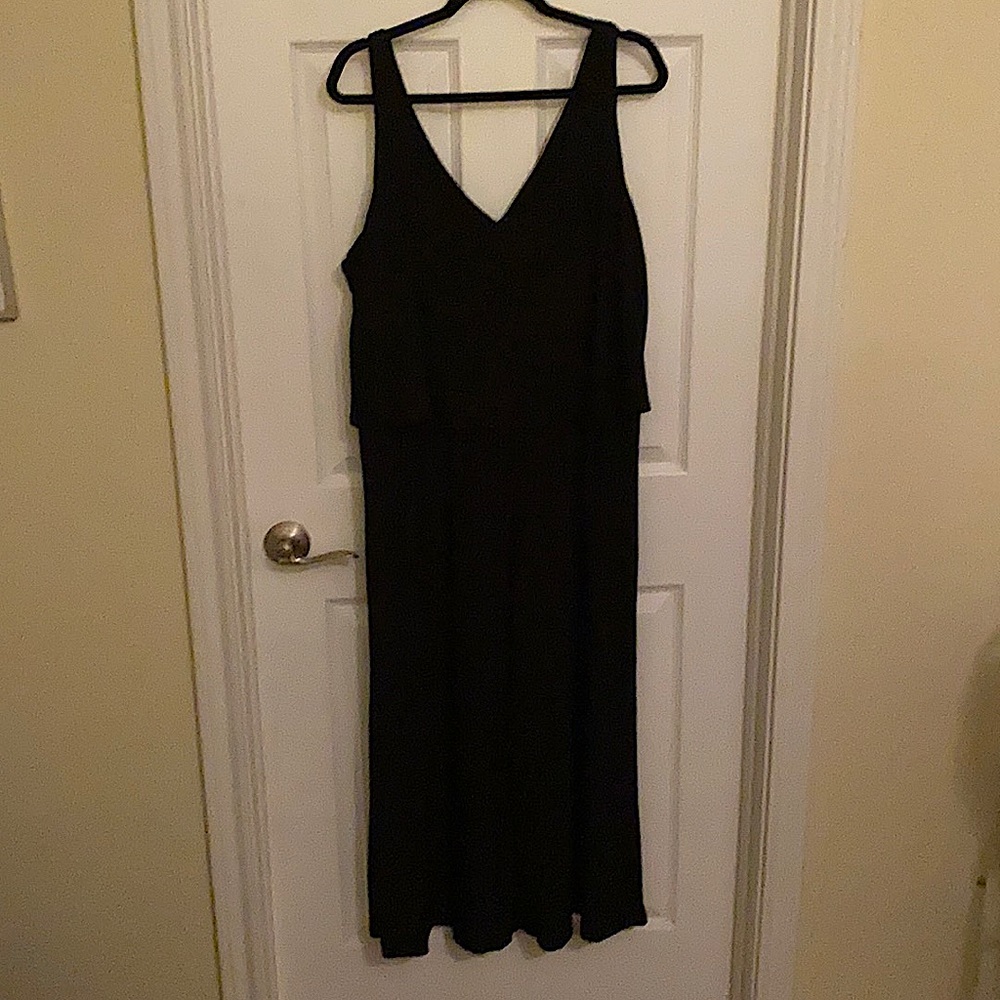 Solid black sleeveless jumpsuit with v-neck cut in front and back.